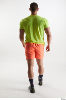 Joel  1 back view dressed green sneakers orange shorts…